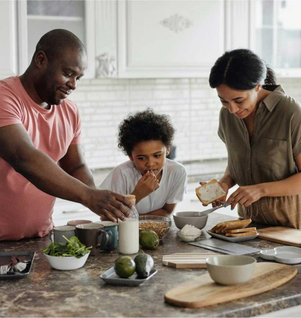 Family Having Breakfast On Kitchen Island